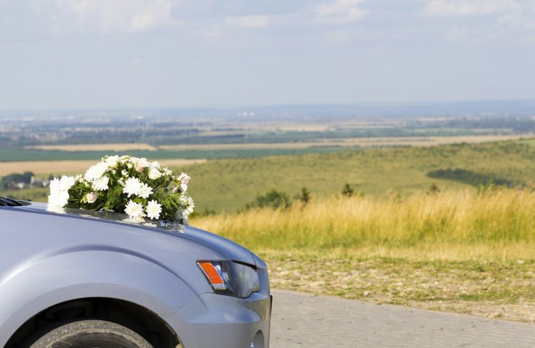 Car with wedding flowers on the hood