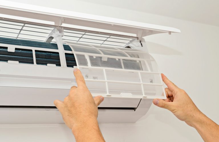Changing the filter of the air conditioner. Changing filter in air conditioning.